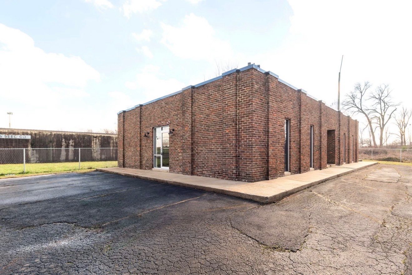 The brick building and glass entrance doors of VEIR Church at Huntsville