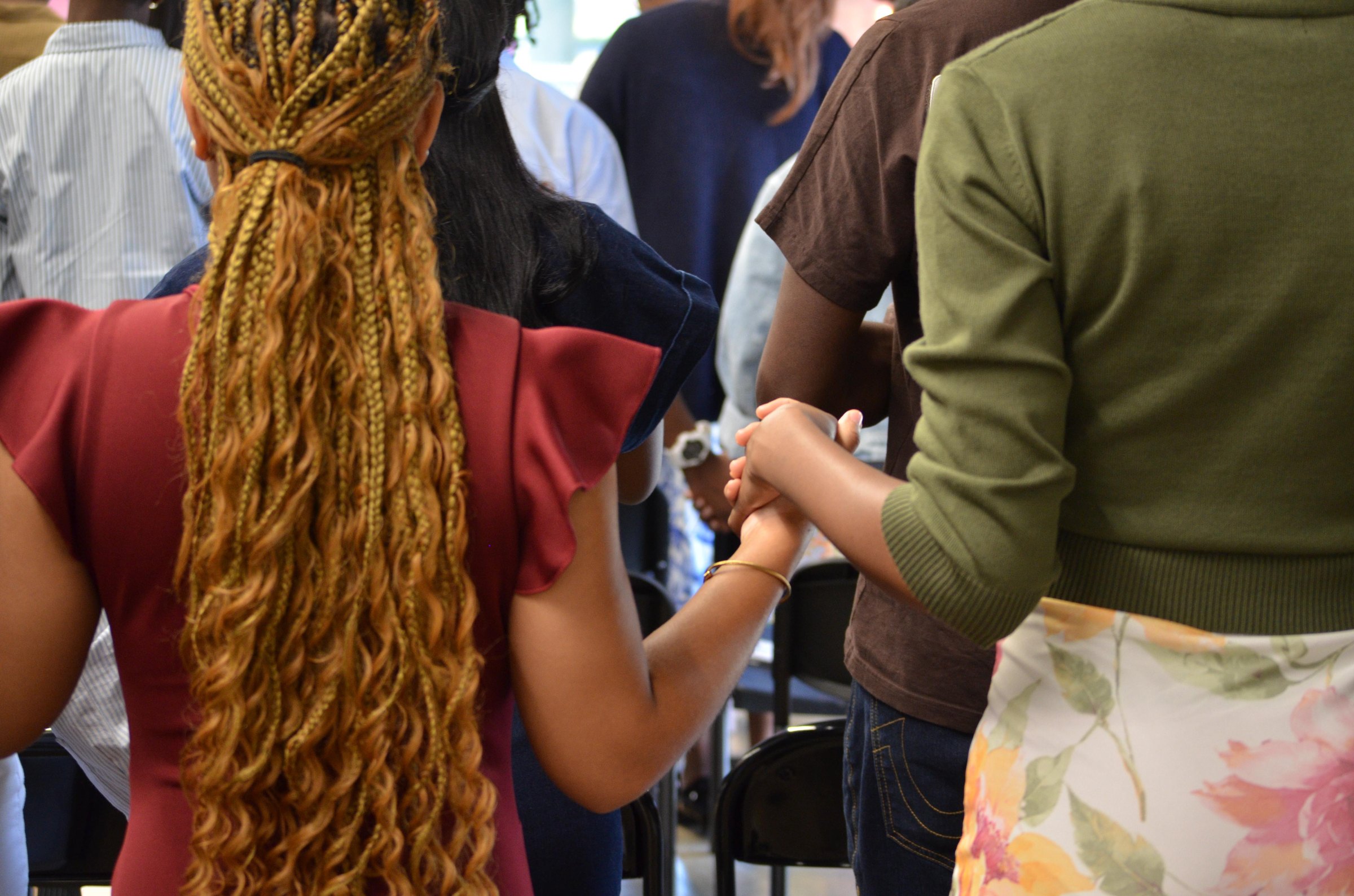 A row of members holding hands